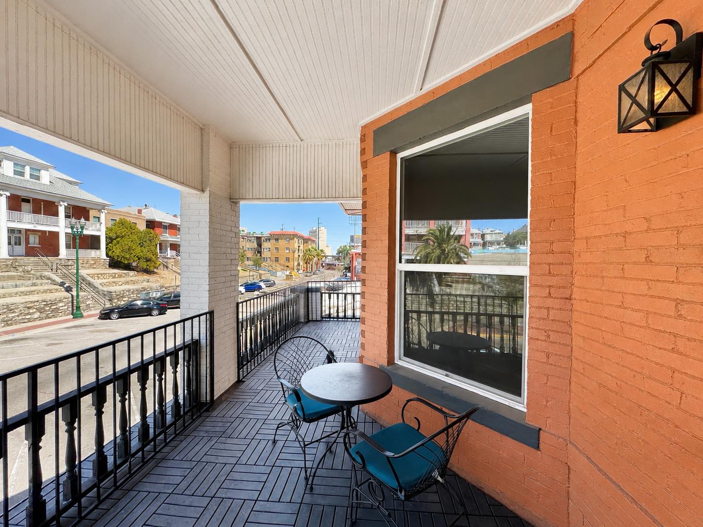 Building balcony with seating overlooking the neighborhood