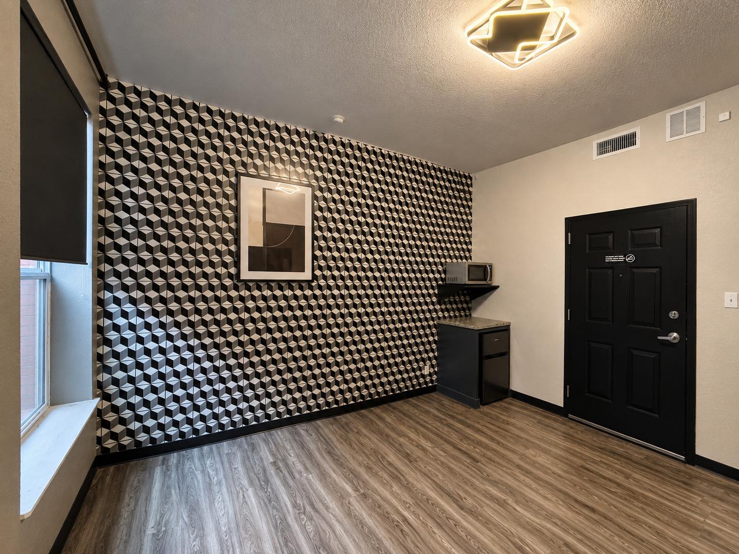 Executive studio showing full room depth and feature wall